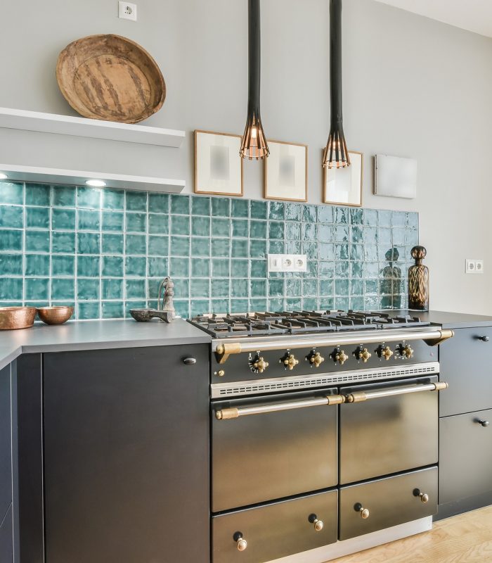 Interior of contemporary kitchen with minimalist style furniture and gas stove in light apartment